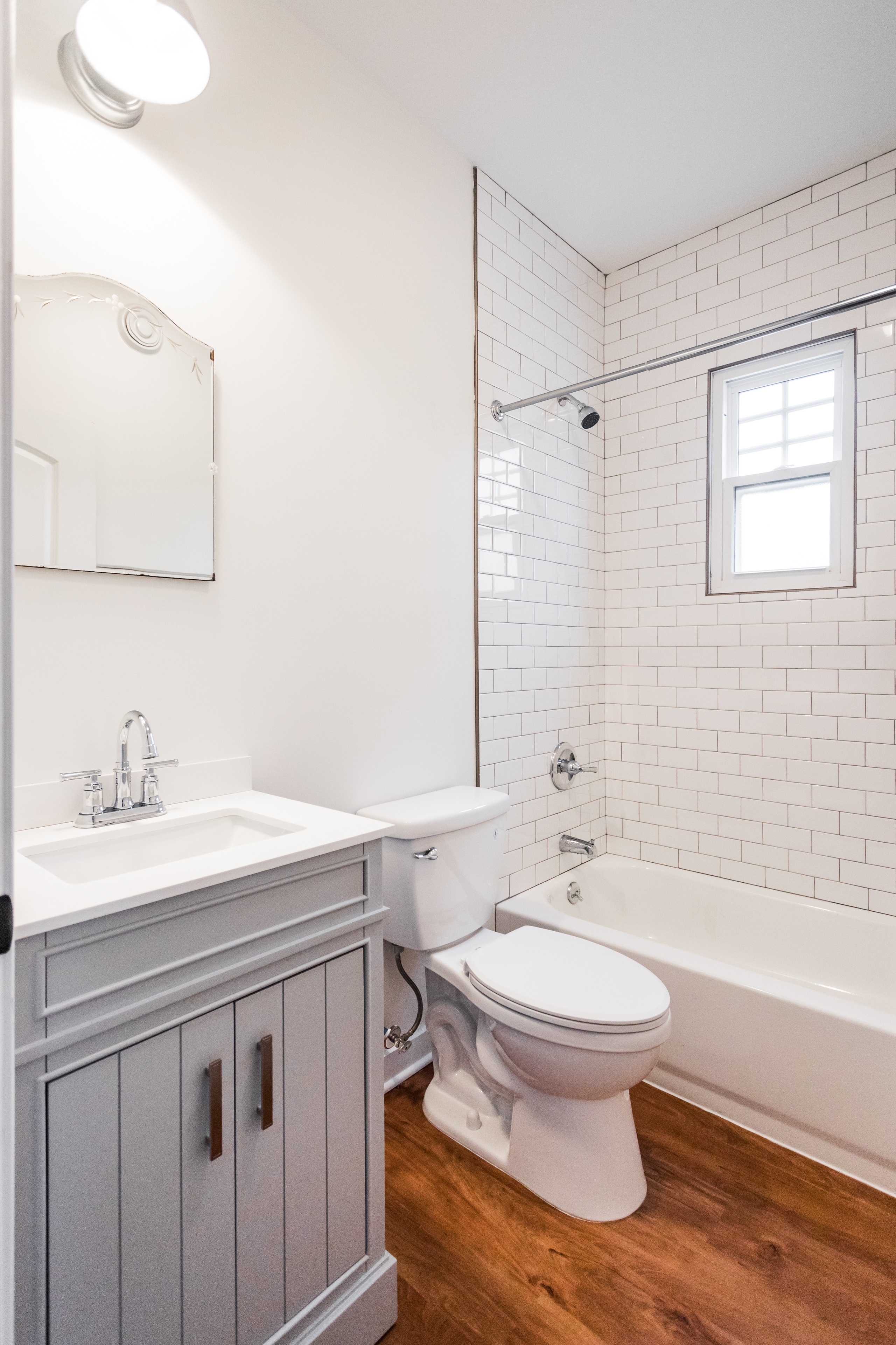 A white toilet sits next to a bathtub in a bathroom.